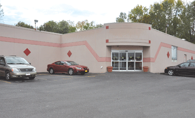 The Flamingo Bowl building — a pink Art Deco bowling center with diamond accents.